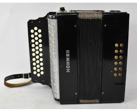 A Hohner 3-row button accordion.