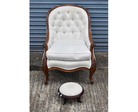 A Victorian style walnut framed button upholstered spoon back armchair, also a modern footstool (2).