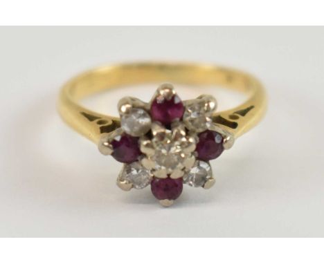 An 18ct yellow gold diamond and ruby flower head ring, size I, approx. 3.6g.