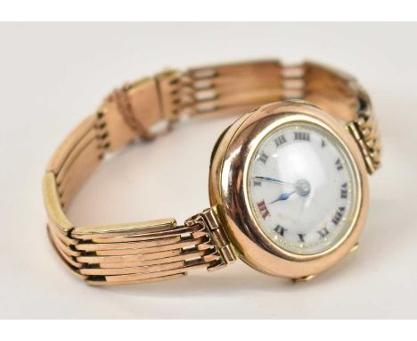 An early 20th century 9ct gold lady's watch with white enamel dial, approx 26.8g.