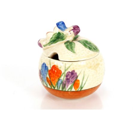 A Clarice Cliff "Crocus" pattern preserve pot, the lid with flower finial, 8cm high 
