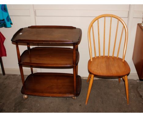 A dark Ercol three tier trolley; and a light Ercol stick back chair 