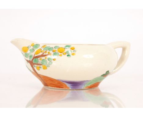A Clarice Cliff style milk jug, with scenic decoration, 17cm overall