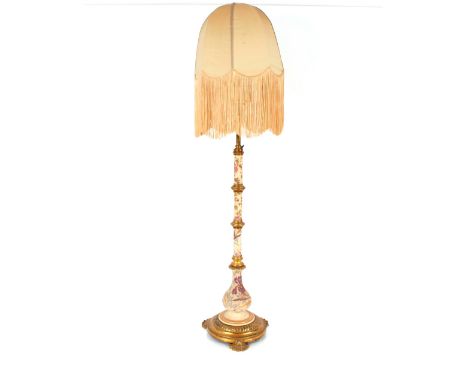 A large and ornate brass and floral pottery standard lamp with tasselled shade, 169cm high overall