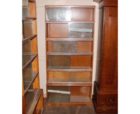 A mid 20th Century light oak six section bookcase, enclosed by glazed sliding doors, 89cm wide x 193cm high