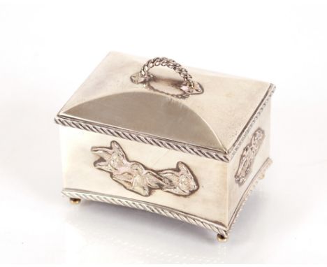 A silver casket shaped musical box, decorated angels