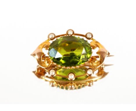 An oval 9ct gold seed pearl and green stone set bar brooch