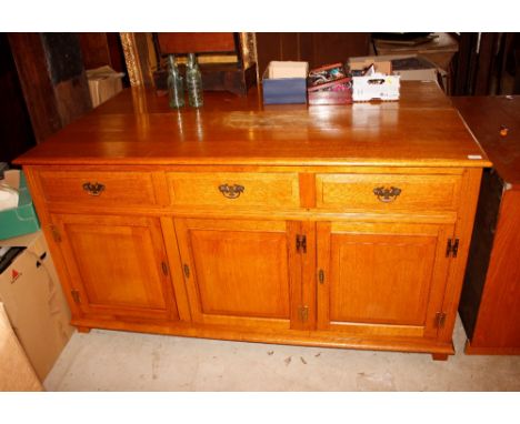 A light oak sideboard fitted three central drawers and cupboards below, enclosed by fielded panel doors, 160cm wide x 51cm de