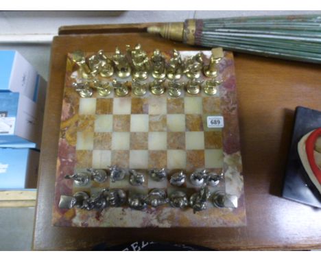Metal chess set with figures of Roman soldiers on heavy marble board