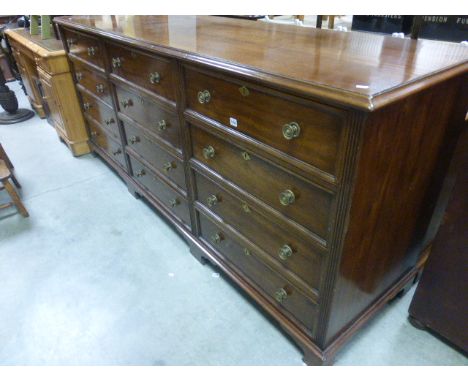 19th century Mahogany Dresser Base comprising Three Banks of Four Drawers, each bank on bracket feet, 226cms long, 98cms high