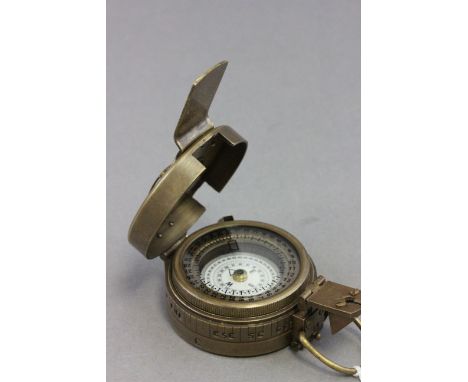 Brass compass marked TG Co Ltd with crows feet and dated 