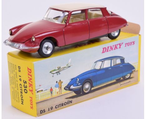 French Dinky 530 Citroén DS 19, red body, cream roof, concave hubs, Dunlop tyres, excellent to mint condition, in yellow box 