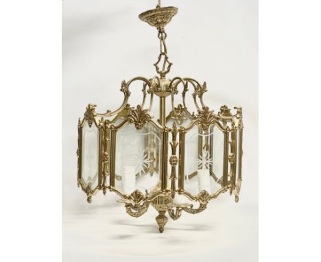 A large ornate brass light fitting with etched glass panels. 46x69cm 