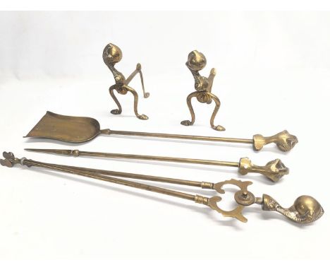 A pair of vintage brass firedogs with vintage brass fire tools 