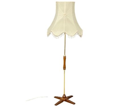A Mid Century teak and brass standard lamp. 164cm 
