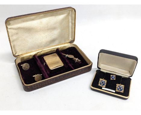 A pair of gold plated Masonic cufflinks with tiepin, with another Masonic set of cufflinks, tie clip and lighter. 