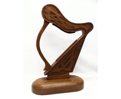 A large carved walnut ornamental harp with Celtic engraving. 75.5x48cm 