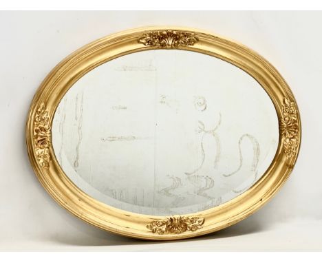 An oval gilt framed mirror. 81x62cm 