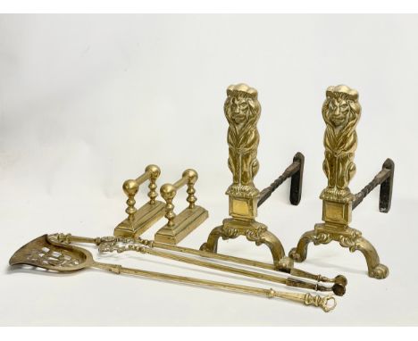 Early 20th century brass fire andirons and tools. Tools measure 78cm. Lion andirons measure 24x40x44cm 