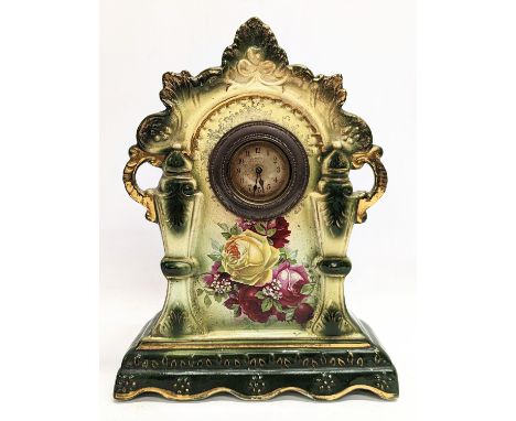 An ornate pottery mantle clock. 23x10x31cm 
