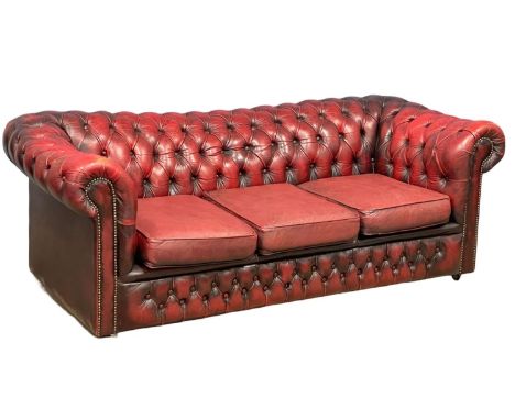 A deep button oxblood leather chesterfield club sofa.  202cm 