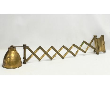 A large vintage brass wall scissor spring lamp. Full extended 97cm. Closed 30cm 