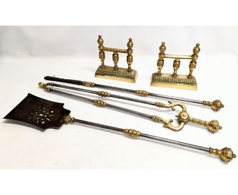 A pair of vintage brass firedogs, with vintage fire tools 