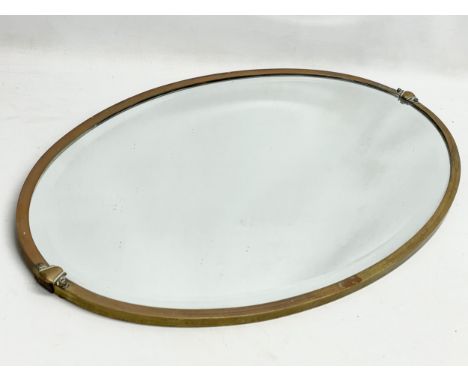 An early 20th century brass framed mirror. Circa 1910-1920. 70x42cm. 