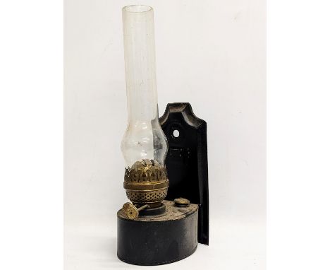 A vintage wall mounted oil lamp. 39.5cm including funnel 
