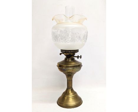 An early 20th century brass double burner oil lamp with glass shade and funnel. 55cm 