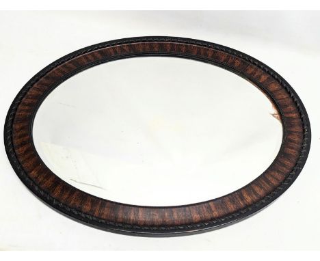 An early 20th century oval bevelled mirror. 71.5x36cm 