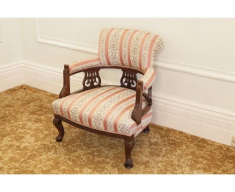 VICTORIAN MAHOGANY TUB SHAPED LOW SEATED NURSING CHAIR UPHOLSTERED AND COVERED IN STRIPED SILK TAPESTRY