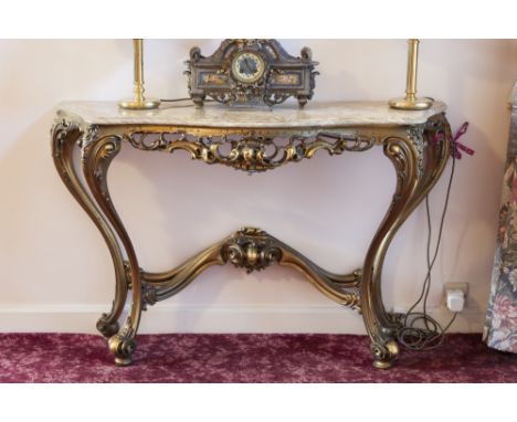 A CARVED AND GILT WOOD ROCOCO CONSOLE TABLE WITH BROWN ONYX TOP WITH SERPENTINE OUTLINE, 4' WIDE