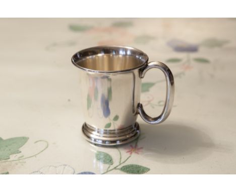 A SILVER CHRISTENING MUG, PLAIN AND TUCKED-IN, ON STEP DOMED BASE, 'C' SCROLL HANDLE, MAKERS EDWARD VINERS, SHEFFIELD, 1953