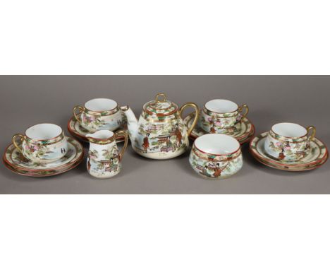 A Noritake fifteen-piece tea service decorated in the Satsuma style (settings for four), the teapot 11cm high (chip to rim).