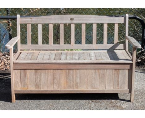 A Firman’s teak garden bench with a hinged boxset, &amp; on short square legs (slight faults – one slat missing), 127.5cm wid