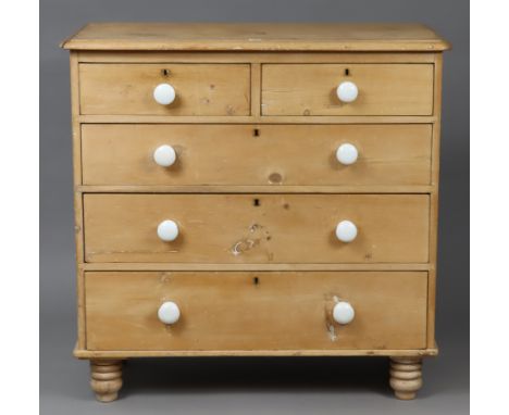 A Victorian pine chest fitted two short &amp; three long graduated drawers with white ceramic knob handles, &amp; on turned f