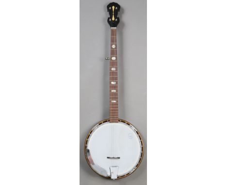 A modern five-string banjo, boxed, with various accessories.