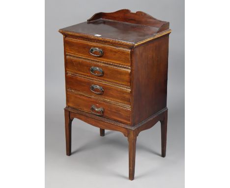 An Edwardian mahogany sheet-music cabinet fitted four long drawers with hinged fall-fronts, &amp; on four short square tapere