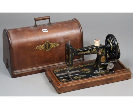 A vintage Singer hand sewing machine, with carrying case.