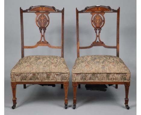 A pair of 19th century marquetry-inlaid rosewood splat-back nursing chairs each with a padded seat, &amp; on square tapered l