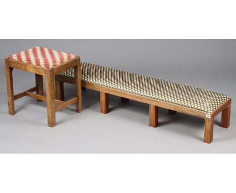 A mahogany fender stool with a padded drop-in-seat, &amp; on eight moulded square legs, 133cm long x 24cm high x 33cm deep; &