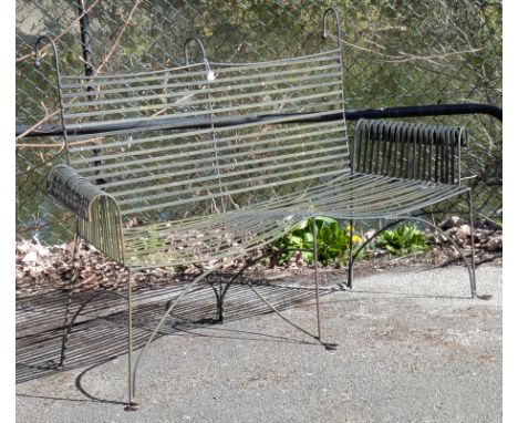 A Victorian-style black painted wrought-iron garden bench with scroll arms &amp; shaped supports, 190cm wide.