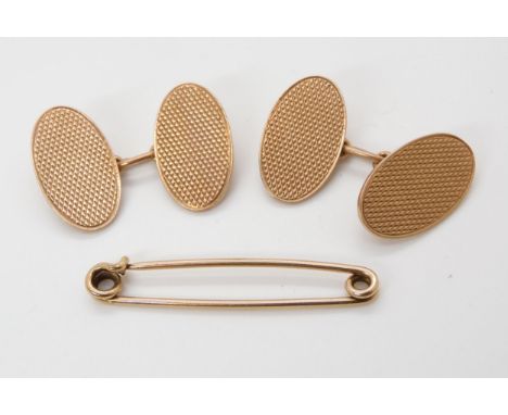 A pair of 9ct gold oval engine turned cufflinks and a yellow metal tie pin, weight together 9.8gms Condition Report:Available