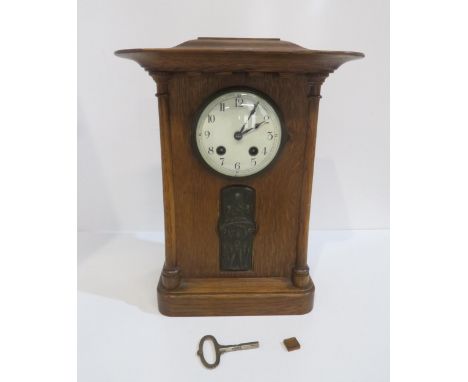 A wooden mantle clock with inlaid metal plaque Condition Report:Available upon request
