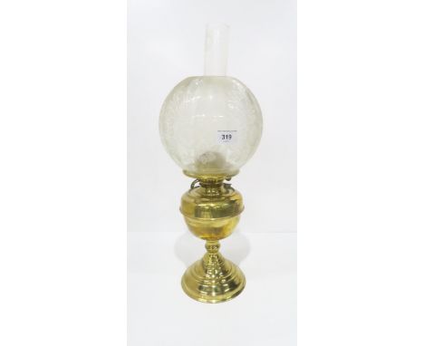 An oil lamp with brass base and etched shade Condition Report:Available upon request