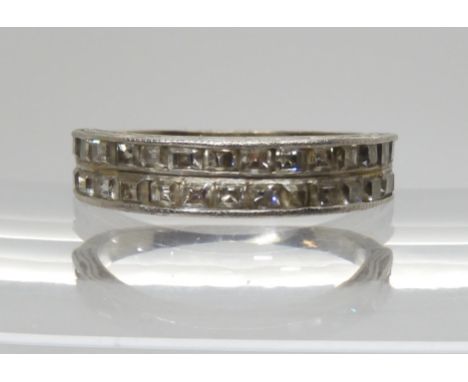 A white metal double row half eternity ring set with step cut diamonds, to an estimated approx total of 1.40 cts, the edge of