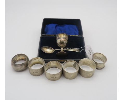 A set of four silver napkin rings, the bodies engine turned, by C W Fletcher &amp; Son, Sheffield 1961, two others, a cased s