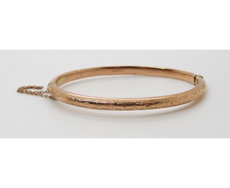 A 9ct gold bangle, with engraved design, weight 7.5gms Condition Report:Available upon request