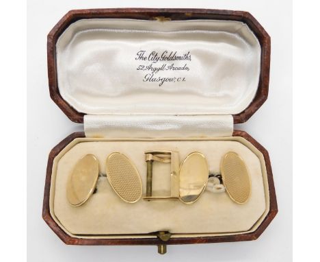 A set of 9ct gold oval engine turned cufflinks in original box and a 9ct gold watch strap buckle weight 10.5gms&nbsp; Conditi